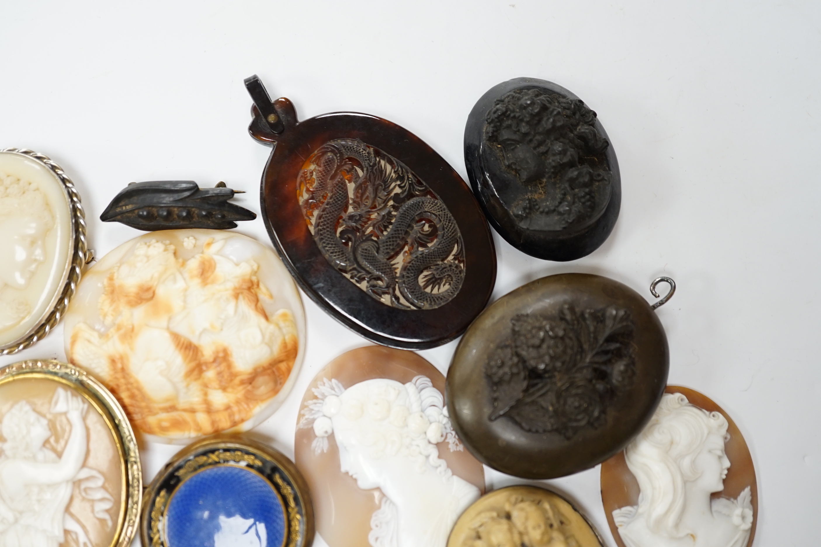 Five assorted unmounted carved cameo shells, largest 57mm, four other mounted cameo brooches including three shell, two base metal vestas and a box and sundry other items.